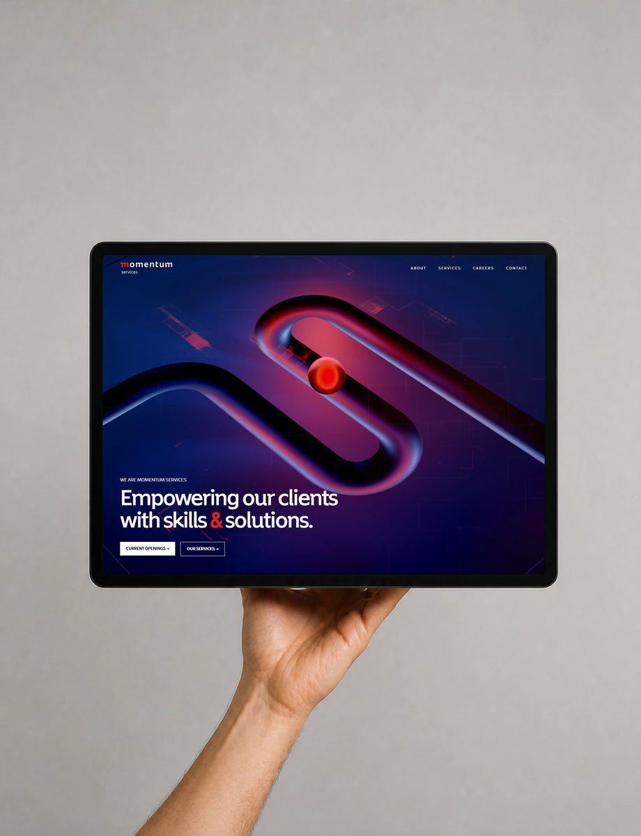 A front-facing tablet displaying Momentum’s cobalt and red services experience, supported by one hand.