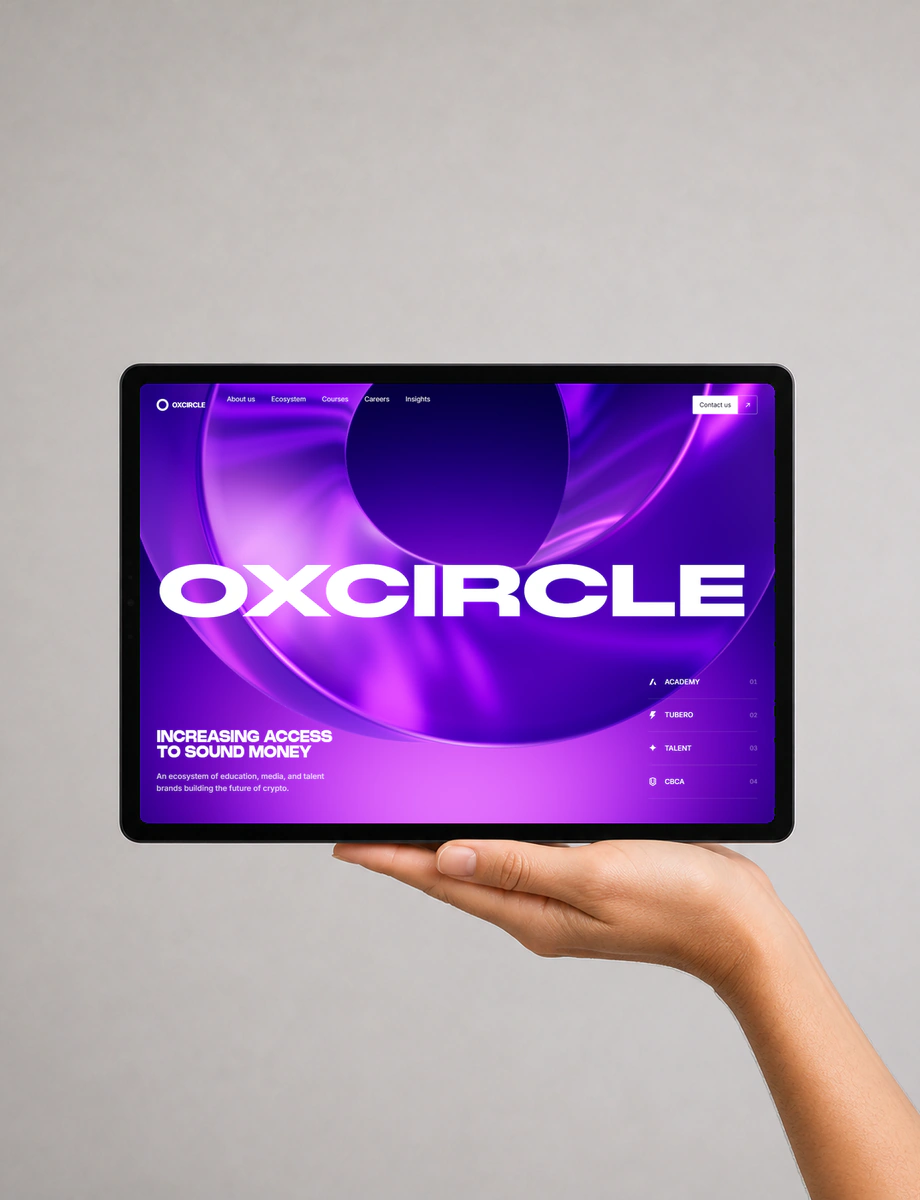 A hand supporting a front-facing tablet displaying the luminous purple OX Circle experience.